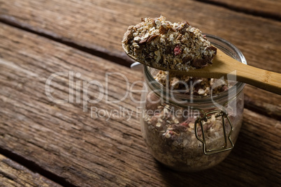 Mixed breakfast cereals on wooden spoon