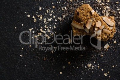 Granola bars with dried coconut and grains on black background