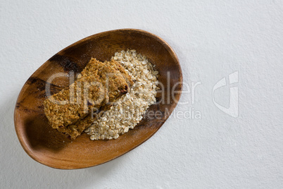 Granola bar and oatmeal in bowl