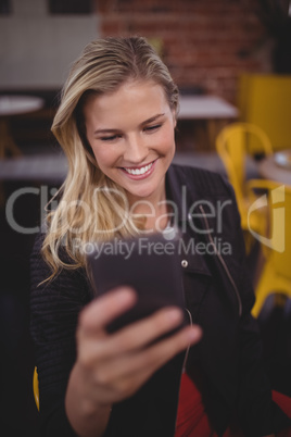 Attractive young woman using mobile phone