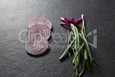 High angle view of onions with green vegetables