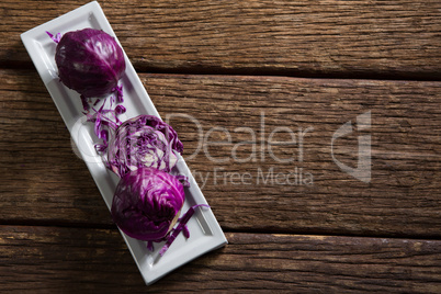 Red cabbage in tray on wooden table