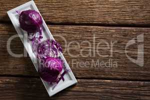 Red cabbage in tray on wooden table