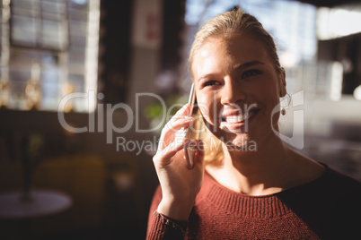 Close up of smiling woman listening to mobile phone