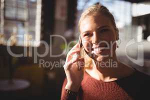 Close up of smiling woman listening to mobile phone
