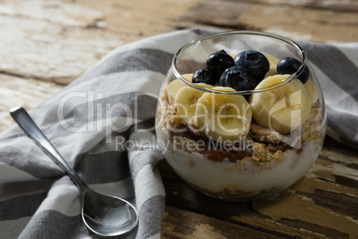 Cup of yogurt muesli, banana and blueberries for breakfast