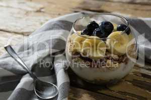Cup of yogurt muesli, banana and blueberries for breakfast