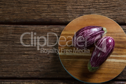 Two eggplant on chopping board