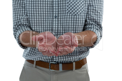 Man with cupped hands against white background