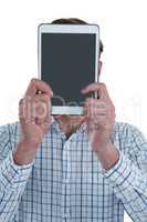 Man holding digital tablet in front of his face