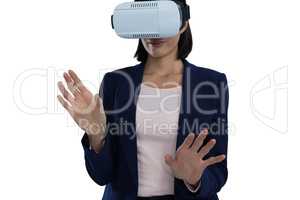 Businesswoman gesturing while using virtual reality headset