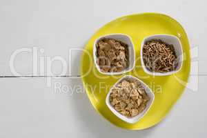 Wheat flakes and cereal bran sticks in bowl