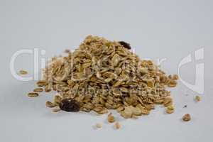 Crunchy granola scattered on white background