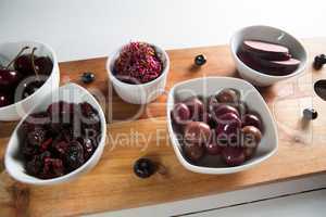 Olives with beetroot slices and various fruits in bowls