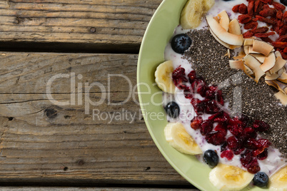 Healthy breakfast in bowl on wooden table
