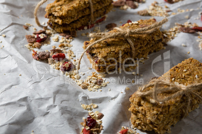 Granola bars tied with string on wax paper