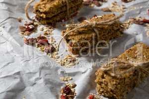 Granola bars tied with string on wax paper