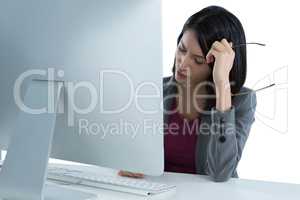 Tired businesswoman sitting at desk
