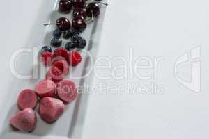 Fruits and vegetables arranged on white background