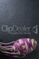 Overhead view of purple root vegetable on slate