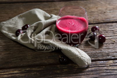 Cherry and juice on wooden table