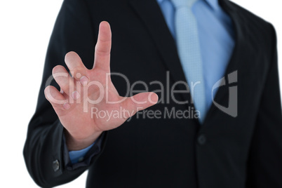 Mid section of businessman touching imaginary interface screen