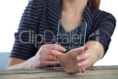 Mid section of businesswoman showing transparent glass interface