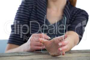 Mid section of businesswoman showing transparent glass interface