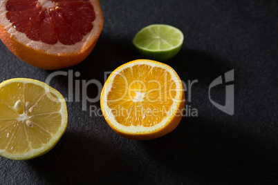 Halved citrus on black background
