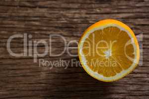 Halved orange on wooden table