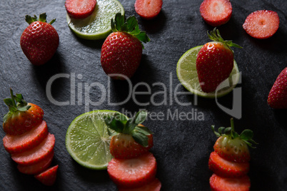 Sliced strawberries and lemon on tray