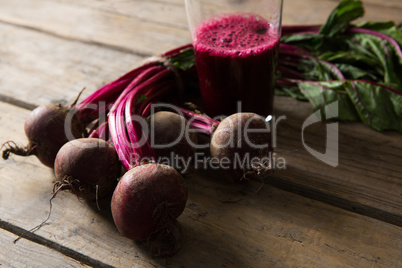 Beetroot and beetroot juice on wooden table