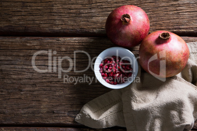 Pomegranate and napkin on wooden table