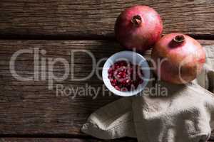 Pomegranate and napkin on wooden table
