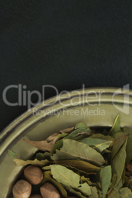 Nutmeg and bay leaf in tray