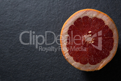 Halved grapefruit on black background