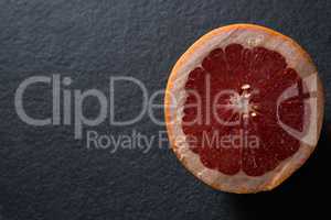 Halved grapefruit on black background