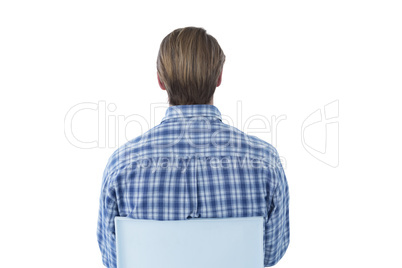 Rear view of businessman sitting on gray chair