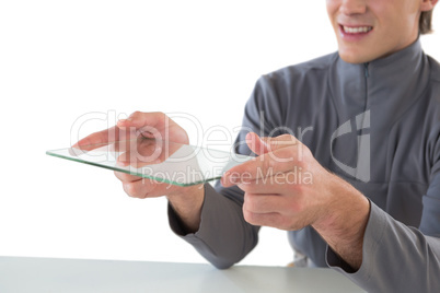 Mid section of smiling businessman giving glass interface