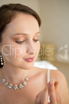 Close up of beautiful bride looking wedding ring at home