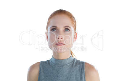 Close up of thoughtful young businesswoman looking up