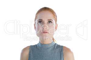 Close up of thoughtful young businesswoman looking up