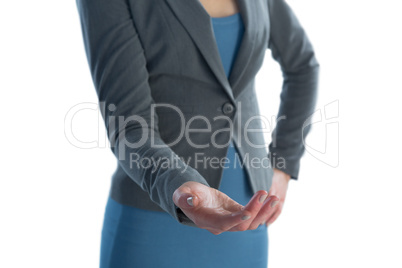 Mid section of businesswoman with hand on hip gesturing against white background