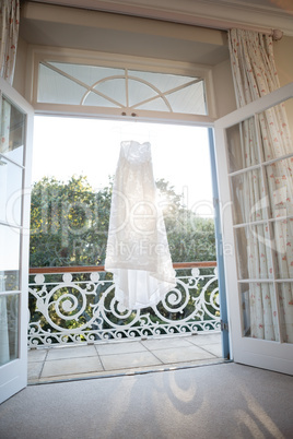 Wedding dress hanging at doorway