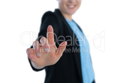 Mid section of smiling businesswoman touching imaginary interface