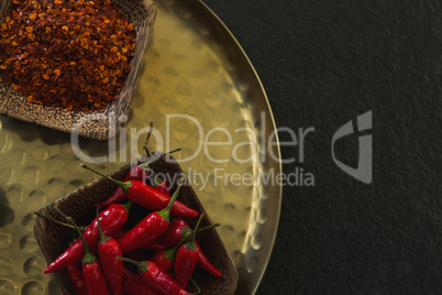 Various spices in tray on black background