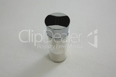 Salt shaker on white background