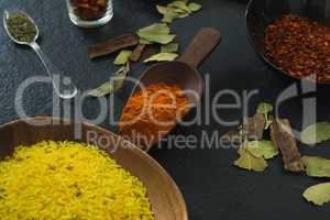 Various spices and rice arranged on table