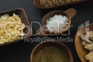 Various spices in bowl on black background
