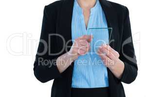 Mid section of businesswoman wearing suit using glass interface